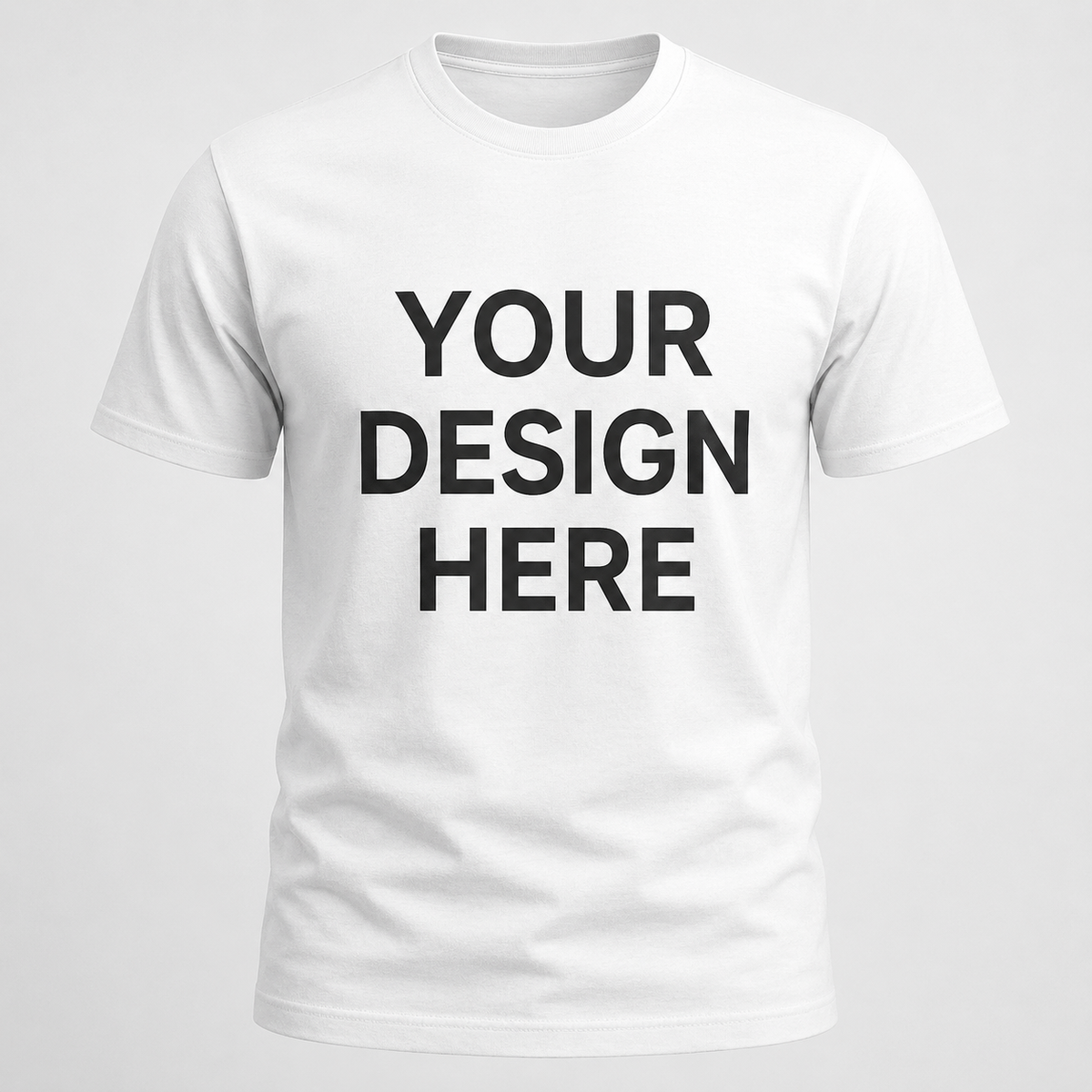 A white short-sleeve crewneck t-shirt with the words 'YOUR DESIGN HERE' printed in bold black capital letters on the chest, shown against a light gray background.